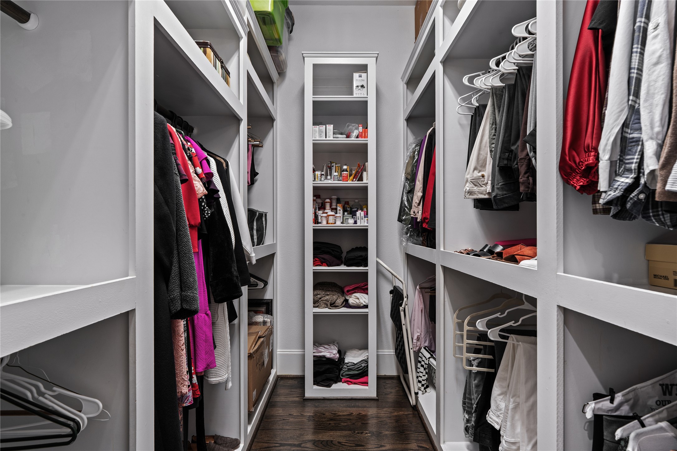 422 West 26th Street Houston, TX 77008 - Photo 25 of 39 The primary walk-in closet is a masterclass in organization, featuring custom built-in shelving, an in-wall safe, and a watch-winder outlet.