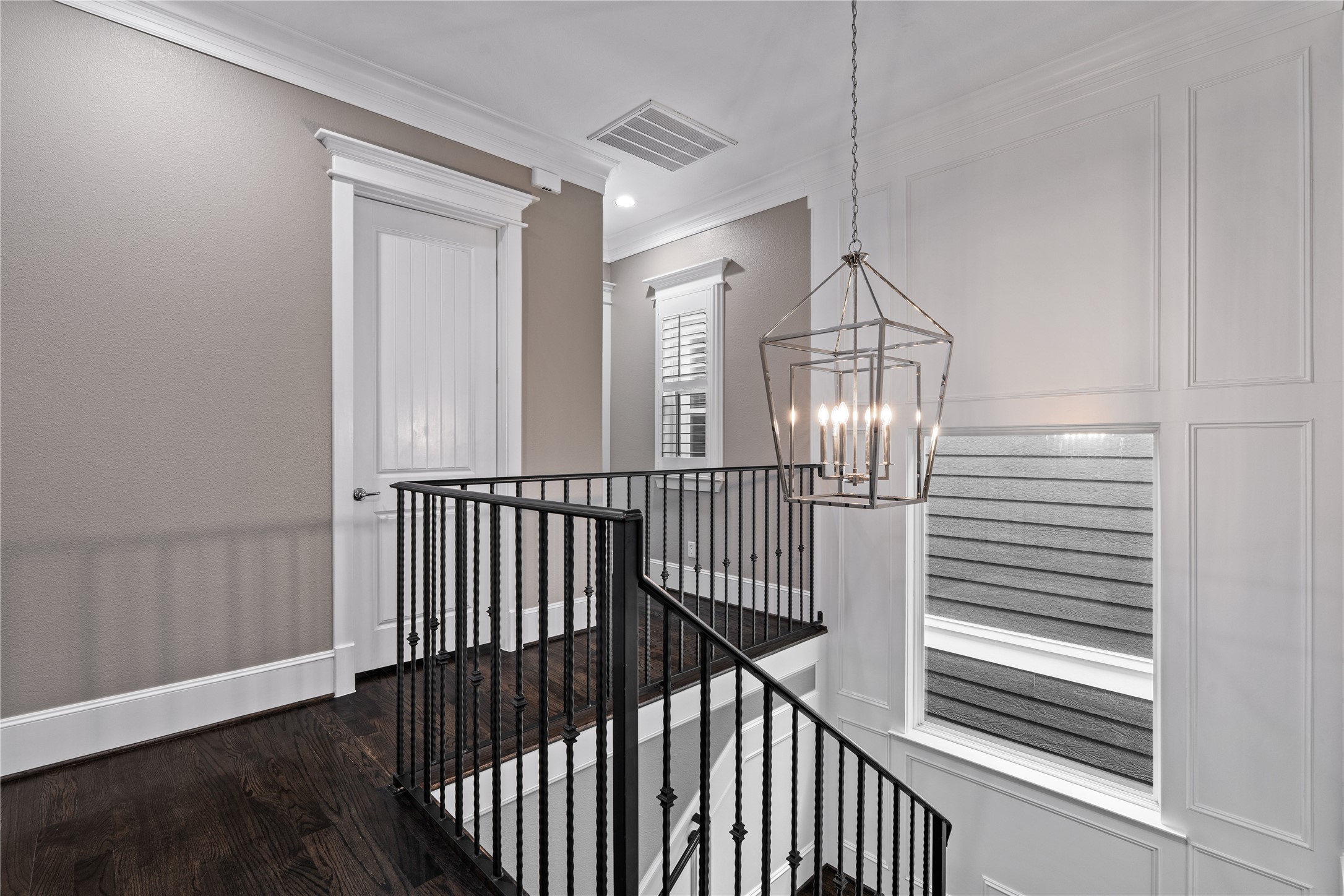 422 West 26th Street Houston, TX 77008 - Photo 26 of 39 A designer lantern-style chandelier illuminates the upper stairway, highlighting the home's high ceilings and architectural detail.