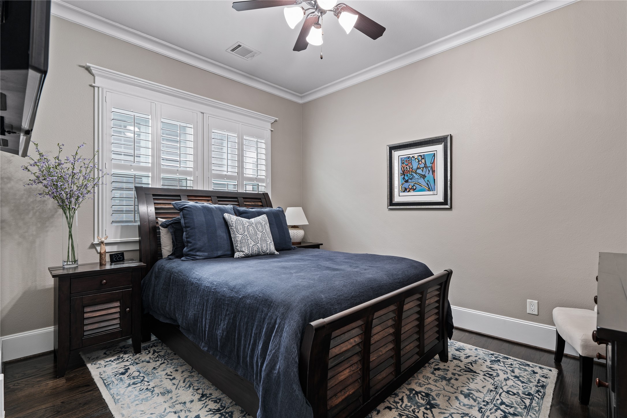 422 West 26th Street Houston, TX 77008 - Photo 28 of 39 Secondary bedrooms are designed for comfort, each featuring rich hardwood floors, plantation shutters, and a newly updated ceiling fan.