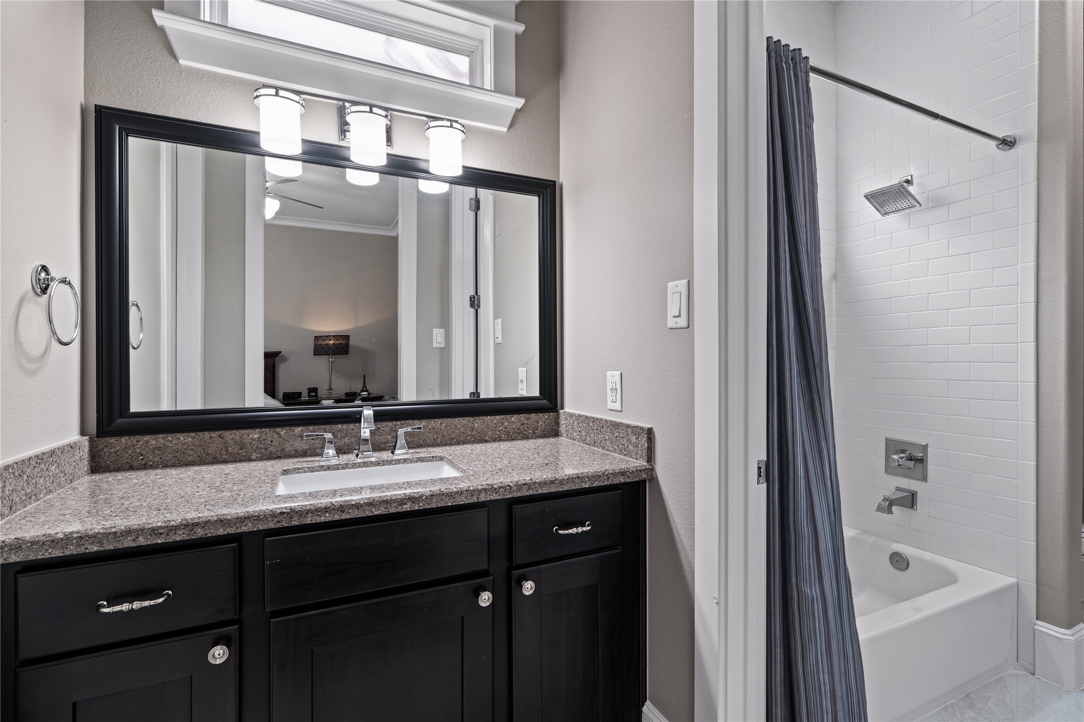 422 West 26th Street Houston, TX 77008 - Photo 30 of 39 The guest bath features a classic tub/shower combo with fresh white subway tile and modern hardware.