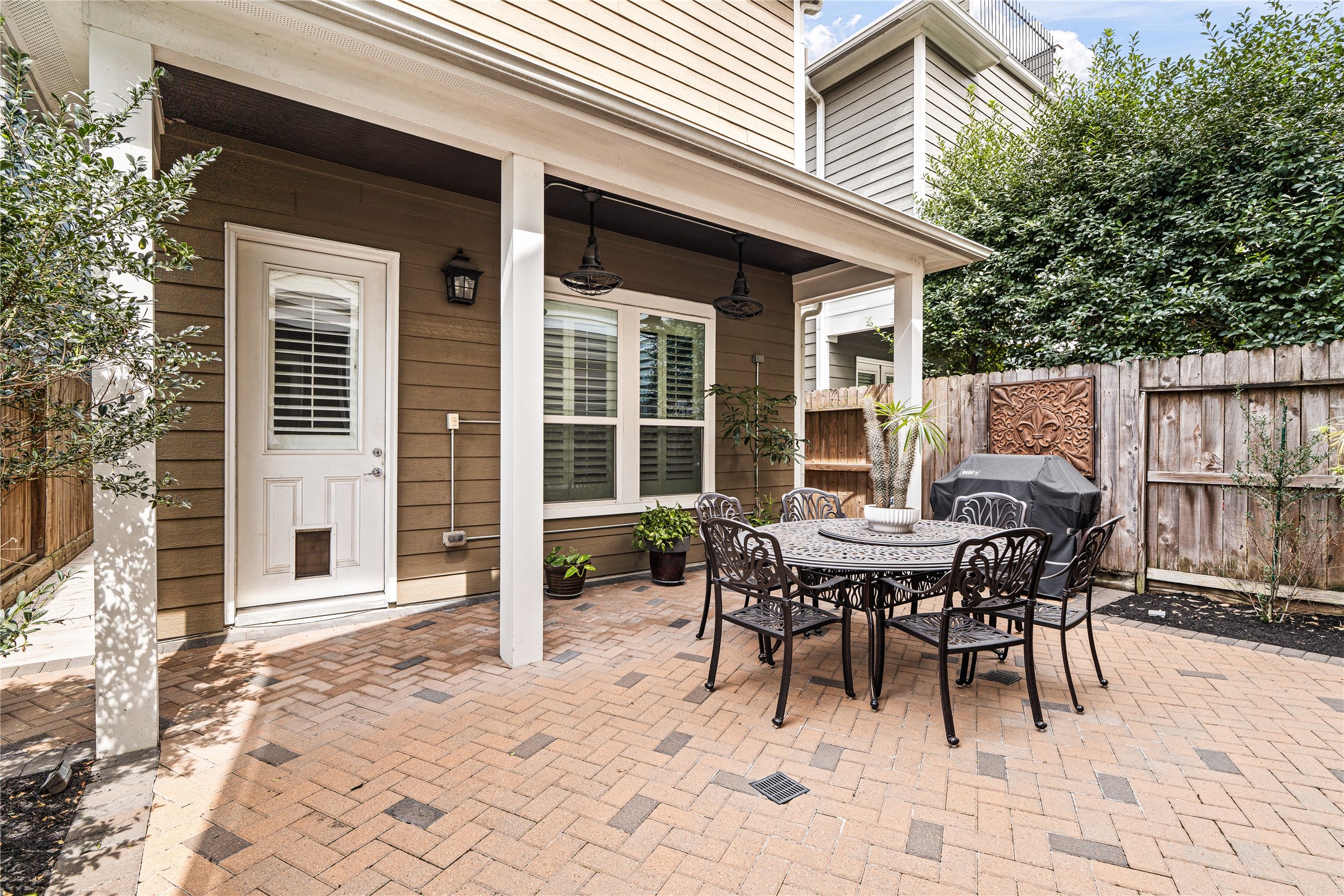 422 West 26th Street Houston, TX 77008 - Photo 34 of 39 The private backyard transitions into a massive brick-paved patio, providing a low-maintenance and sophisticated space for outdoor dining and weekend BBQs.