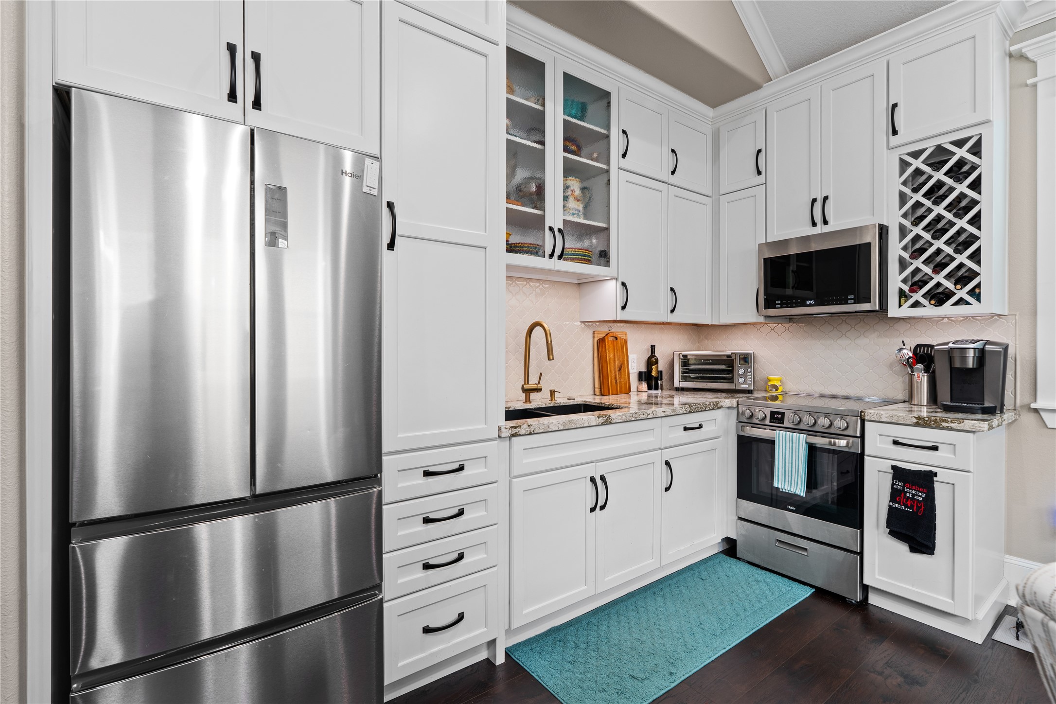 422 West 26th Street Houston, TX 77008 - Photo 36 of 39 The apartment's fully equipped kitchenette is anchored by crisp white cabinetry, granite countertops, and a full suite of appliances for total independence.