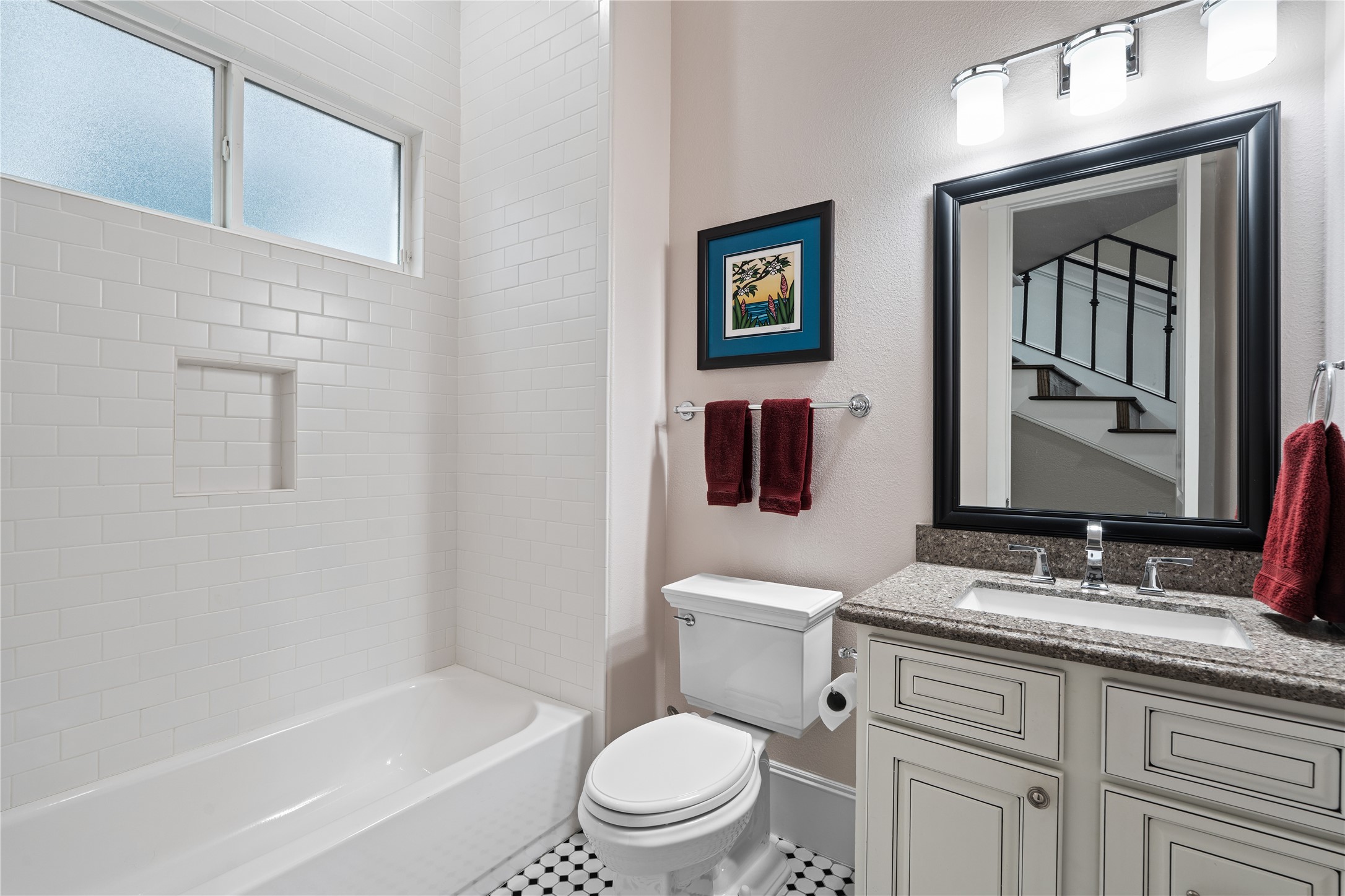 422 West 26th Street Houston, TX 77008 - Photo 8 of 39 The first floor features a full guest bathroom with a granite-topped vanity and a classic subway tile tub/shower combo.