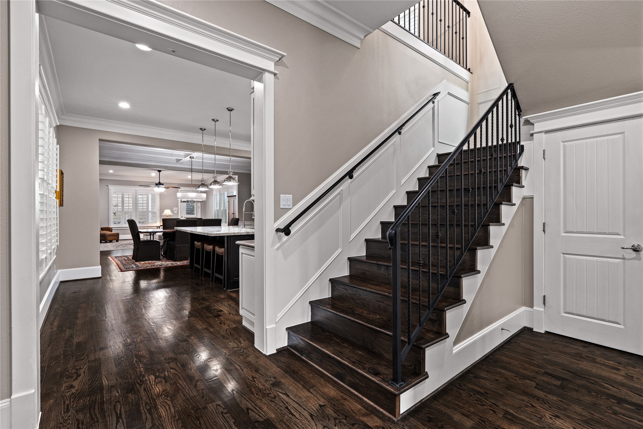 422 West 26th Street Houston, TX 77008 - Photo 9 of 39 An elegant wood staircase with wrought-iron spindles serves as a focal point near the transition into the main living areas.