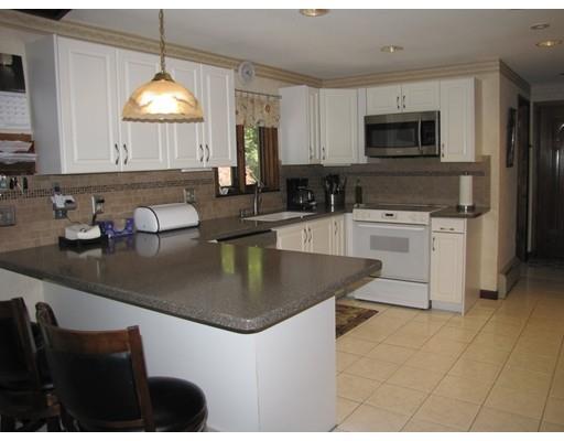 39 Carrington Road Montgomery, MA 01085 - Photo 5 of 23 a kitchen with kitchen island granite countertop a sink a counter top space appliances and cabinets