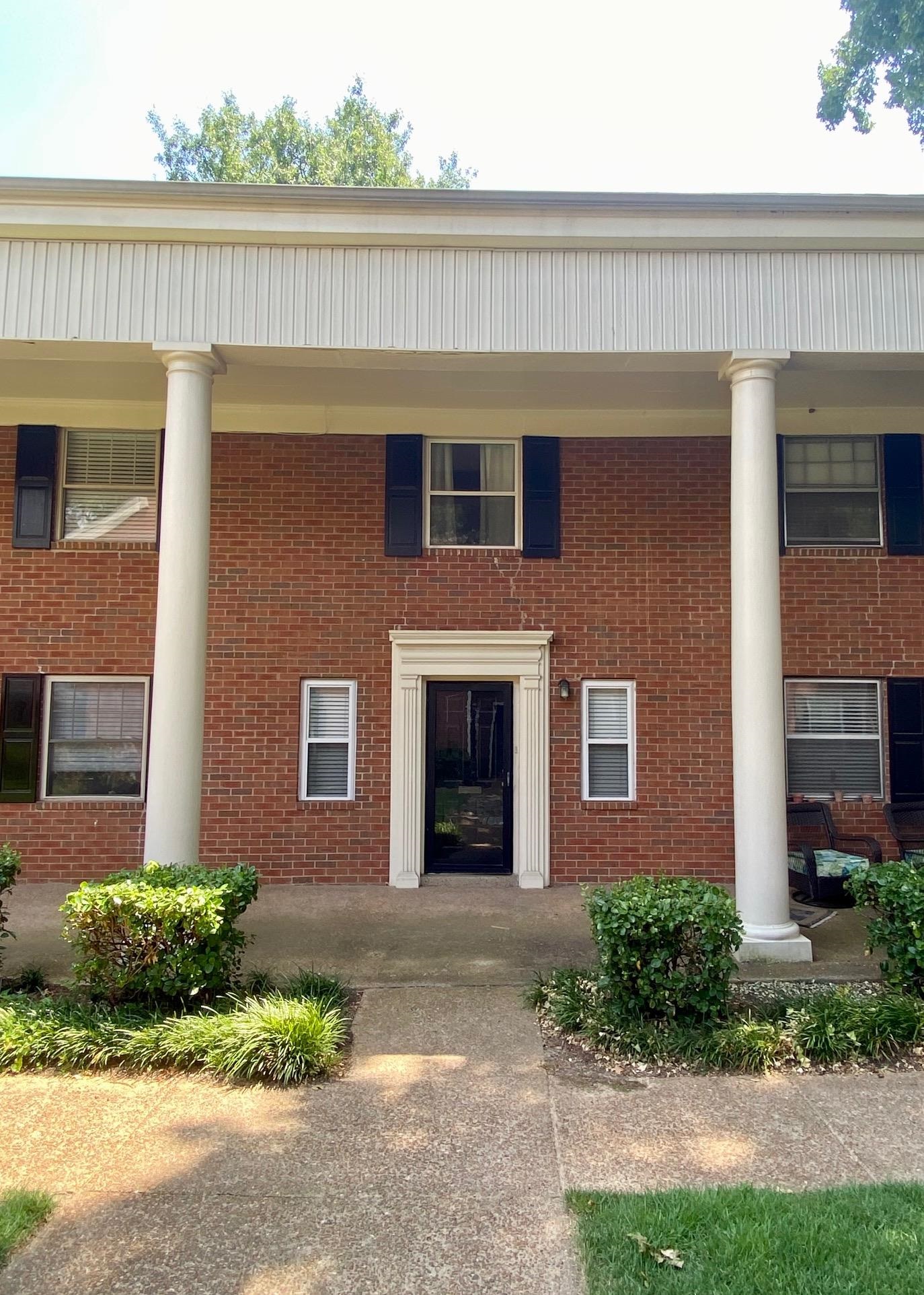 5700 Quince Road, Unit 4 Memphis, TN 38119 - Photo 1 of 16 a front view of a house with garden and garage