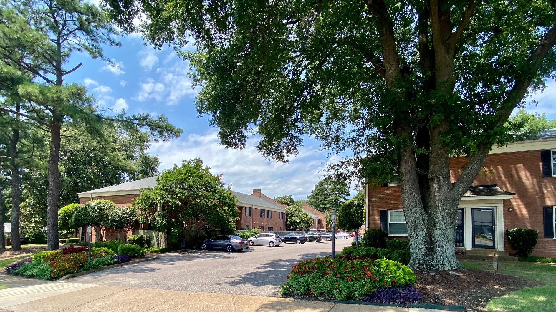 5700 Quince Road, Unit 4 Memphis, TN 38119 - Photo 15 of 16 a front view of a house with a yard and trees
