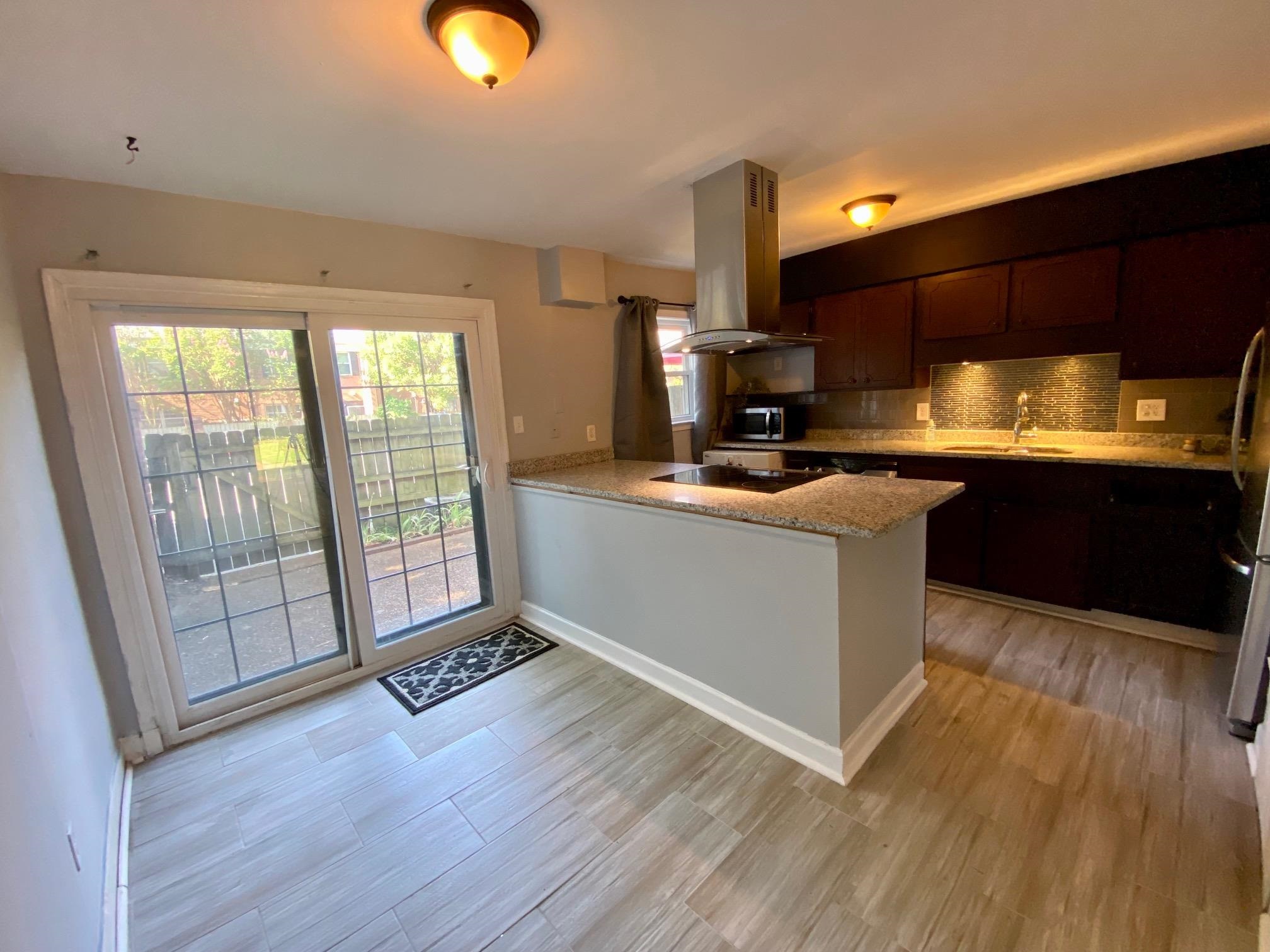 5700 Quince Road, Unit 4 Memphis, TN 38119 - Photo 5 of 16 a kitchen with stainless steel appliances granite countertop a sink a stove and a wooden floors
