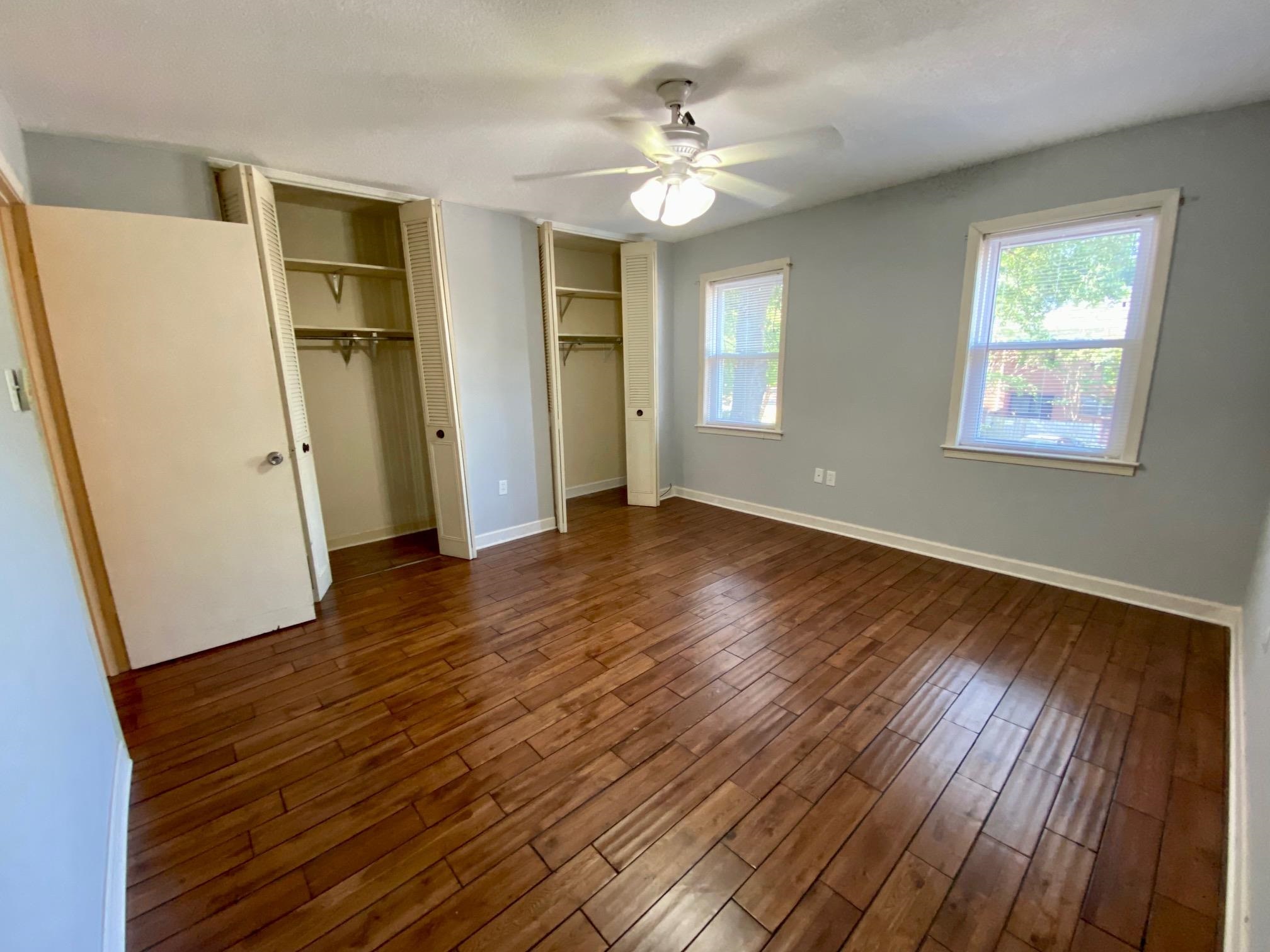 5700 Quince Road, Unit 4 Memphis, TN 38119 - Photo 10 of 16 a view of an empty room with wooden floor and a window