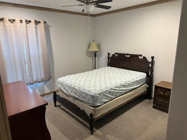 a bedroom with a bed and window