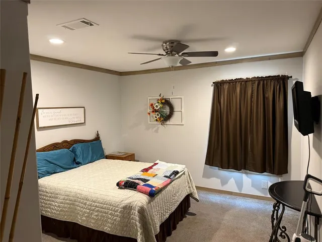 a bedroom with a bed and a mirror