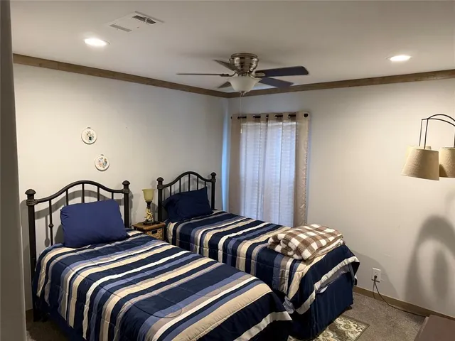 a bedroom with two beds and painting on the wall