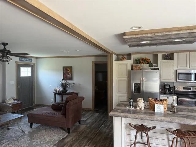 a living room with furniture and a chandelier