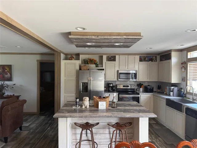 a kitchen with kitchen island granite countertop a sink and counter space