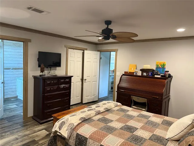 a bedroom with a bed and a television