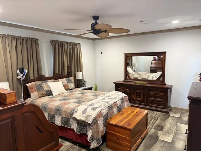 a bedroom with a bed and a dresser in it