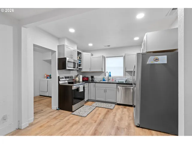 a kitchen with a refrigerator and a sink