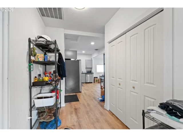 a kitchen with stainless steel appliances kitchen island granite countertop a refrigerator and a sink