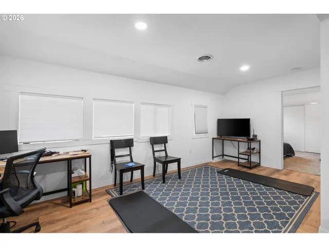 a room with furniture a rug and a flat screen tv