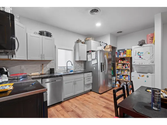 a kitchen with stainless steel appliances granite countertop a refrigerator and a sink
