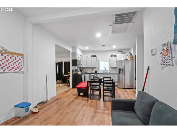 a living room with furniture and kitchen view
