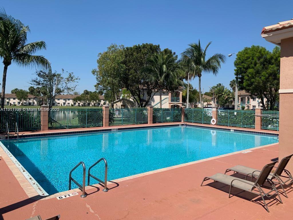 2920 Southeast 13th Road, Unit 20245 Homestead, FL 33035 - Photo 2 of 20 a view of a swimming pool with a table and chairs