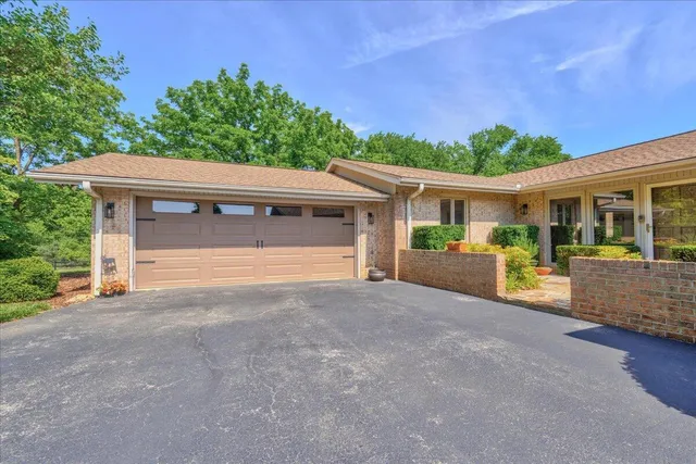 an aerial view of a house with garden space and street view