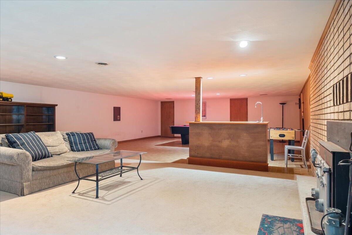 453 Wirtz Road Wirtz, VA 24184 - Photo 46 of 69 a living room with furniture a fireplace and a flat screen tv