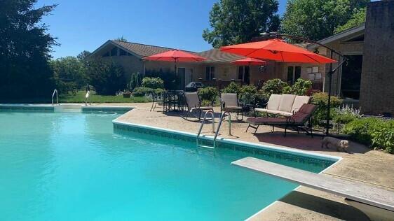 453 Wirtz Road Wirtz, VA 24184 - Photo 62 of 69 a view of a patio with chairs and a table under an umbrella