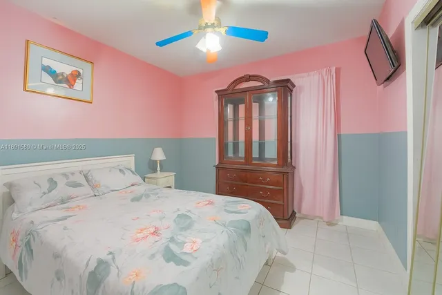 a bedroom with a bed dresser and a window