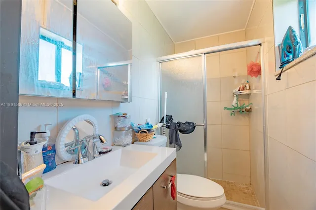 a bathroom with a sink toilet and shower