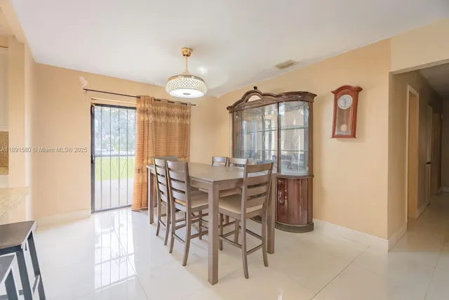 a view of a dining room with furniture and chandelier