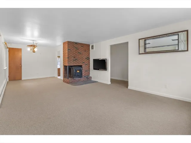 a view of an empty room with a fireplace