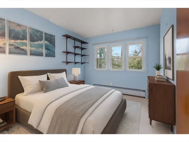 a bedroom with a large bed and a window