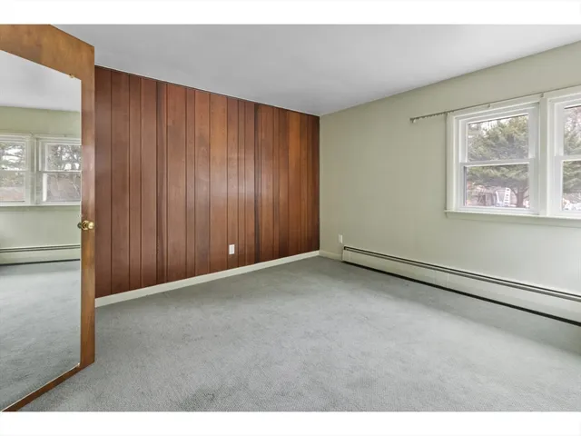 a kitchen with stainless steel appliances granite countertop a sink window and cabinets