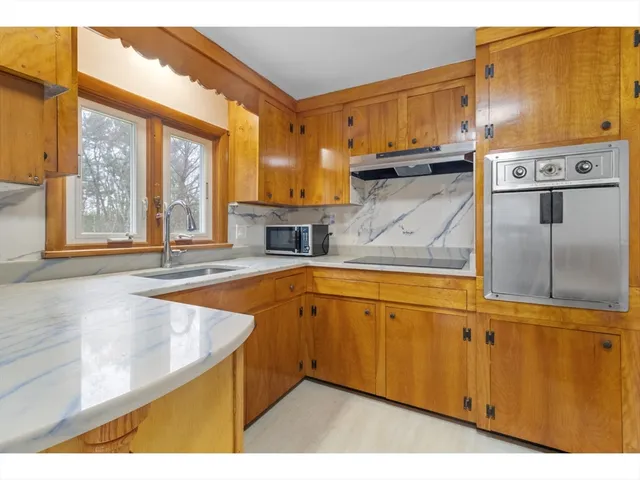 a kitchen with stainless steel appliances granite countertop a sink dishwasher and a refrigerator