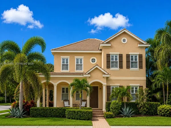 a front view of a house with yard and green space