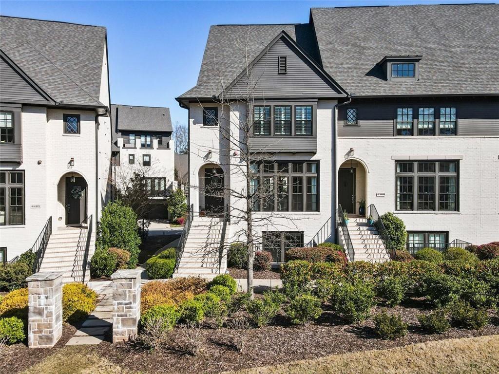 6408 Radiant Trace Atlanta, GA 30328 - Photo 1 of 40 a front view of a house with garden