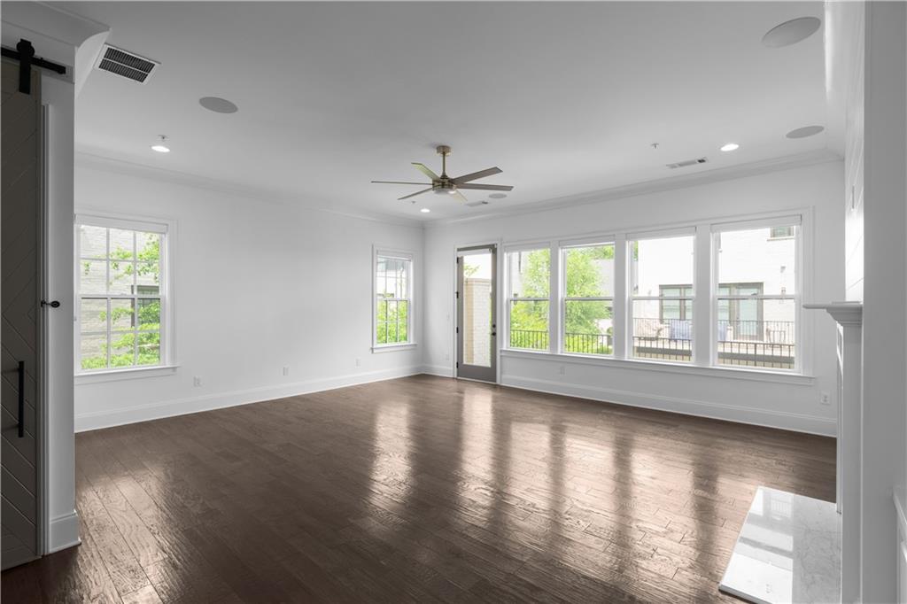 6408 Radiant Trace Atlanta, GA 30328 - Photo 12 of 40 a view of an empty room with wooden floor and a window