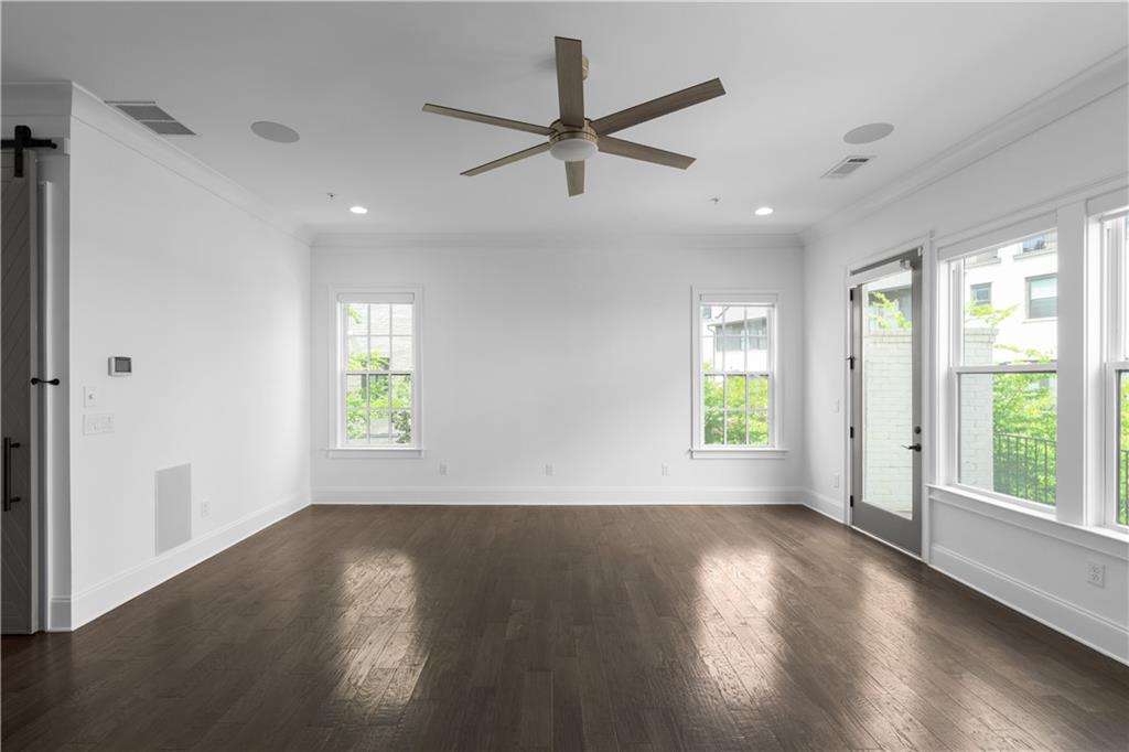 6408 Radiant Trace Atlanta, GA 30328 - Photo 13 of 40 a view of an empty room with wooden floor and a window