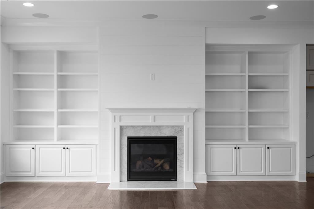 6408 Radiant Trace Atlanta, GA 30328 - Photo 14 of 40 a living room with a fireplace cabinet and a fireplace