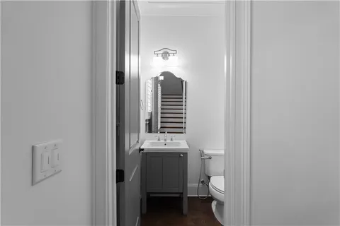 a bathroom with a toilet a sink and mirror