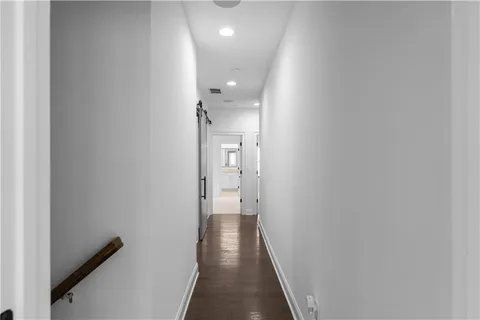 a view of hallway with wooden floor