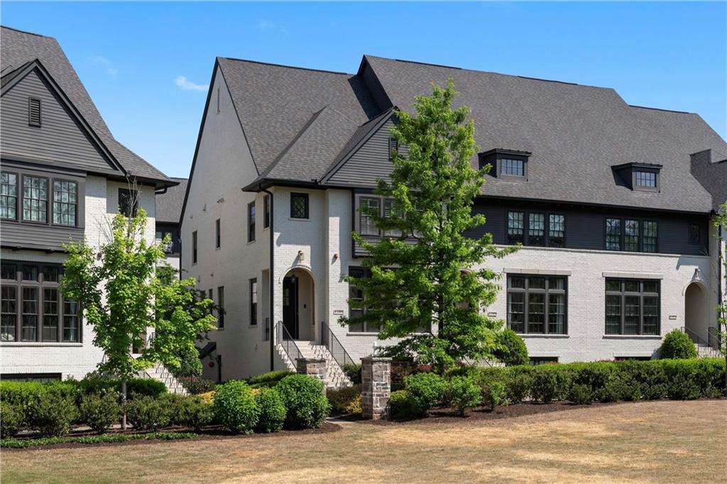 6408 Radiant Trace Atlanta, GA 30328 - Photo 2 of 40 a front view of a house with garden