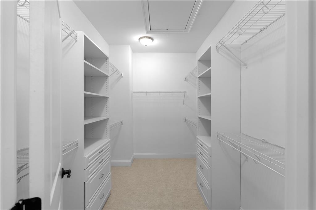 6408 Radiant Trace Atlanta, GA 30328 - Photo 24 of 40 a view of walk in closet with empty racks