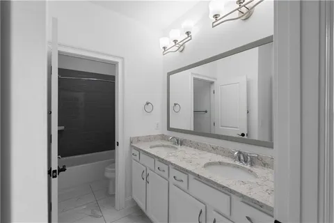 a bathroom with a granite countertop sink mirror and double