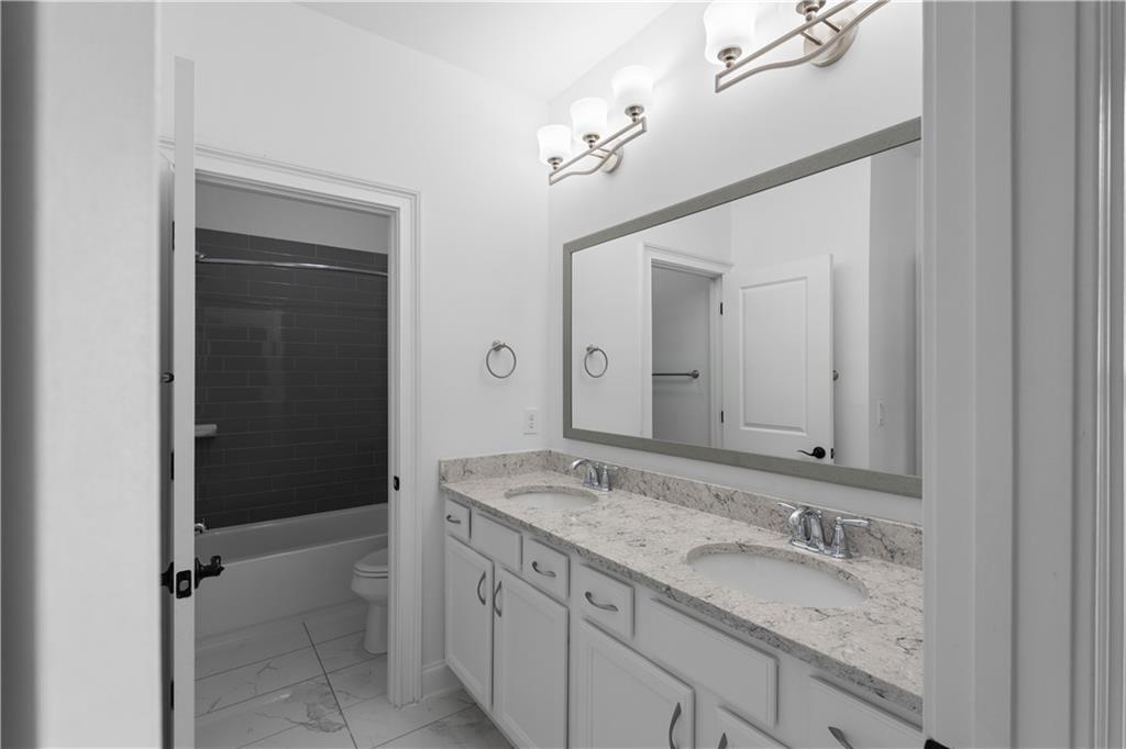 6408 Radiant Trace Atlanta, GA 30328 - Photo 30 of 40 a bathroom with a granite countertop sink mirror and double