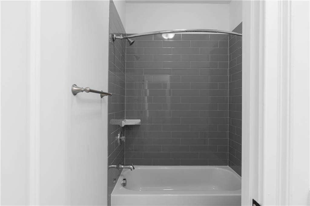 6408 Radiant Trace Atlanta, GA 30328 - Photo 31 of 40 a bathroom with a bathtub
