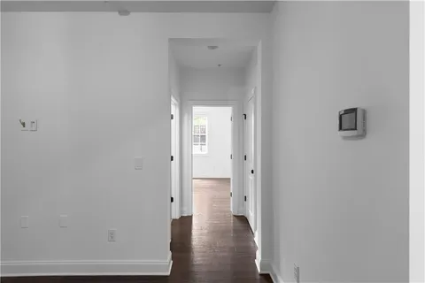 a view of a hallway with wooden floor