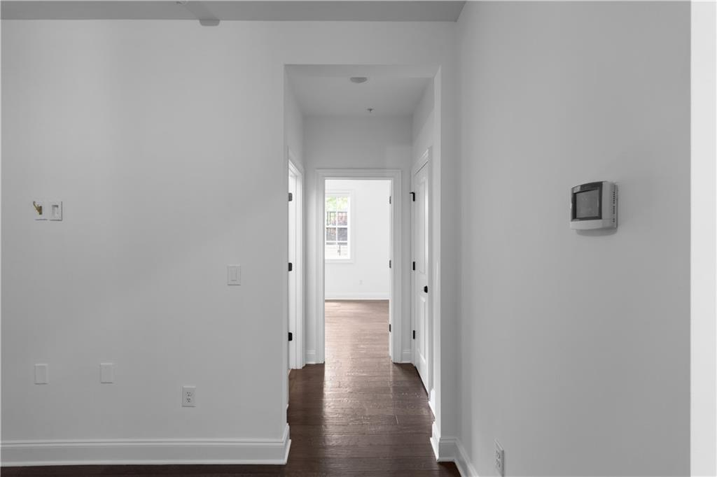 6408 Radiant Trace Atlanta, GA 30328 - Photo 33 of 40 a view of a hallway with wooden floor